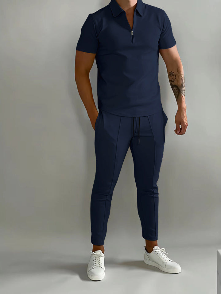 Tweedelige herenset in marineblauw met ritspolo en enkelbroek