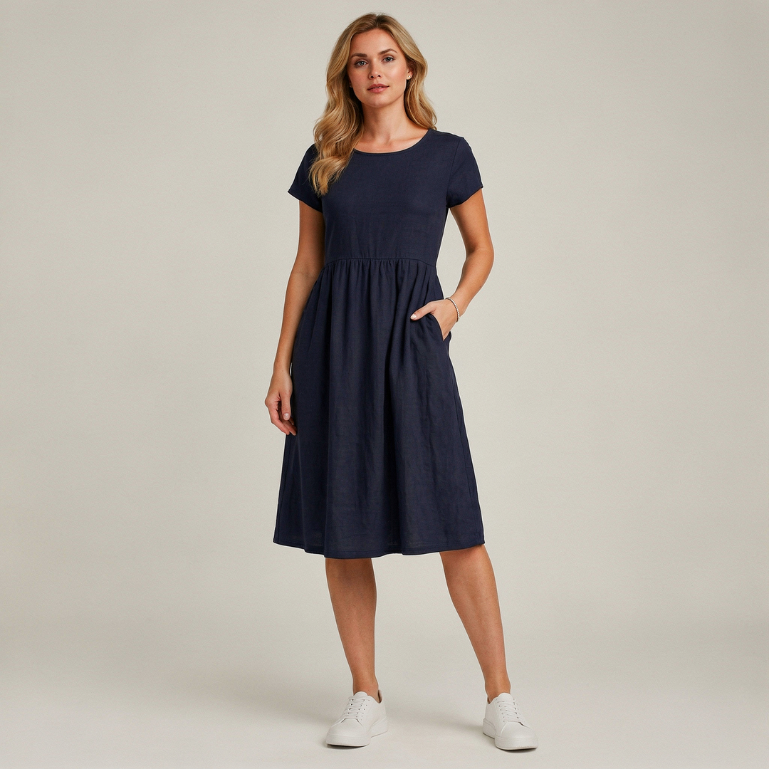 Dames Midi Jurk Met Korte Mouwen En Steekzakken in Donkerblauw, gedragen met witte sneakers