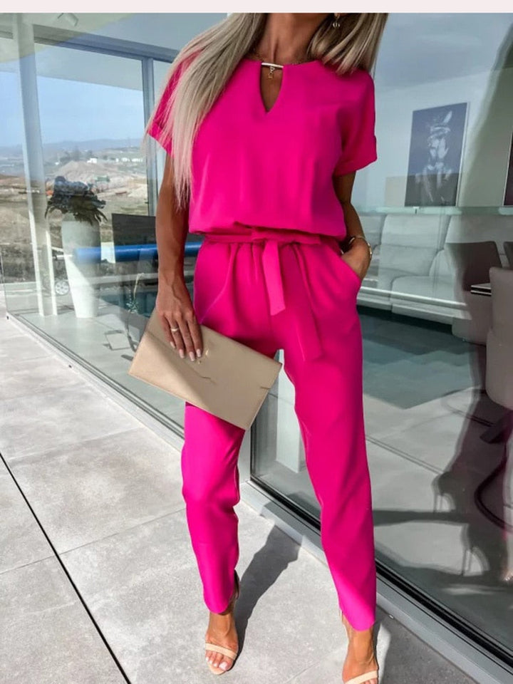 Dames jumpsuit in fuchsia met strikceintuur