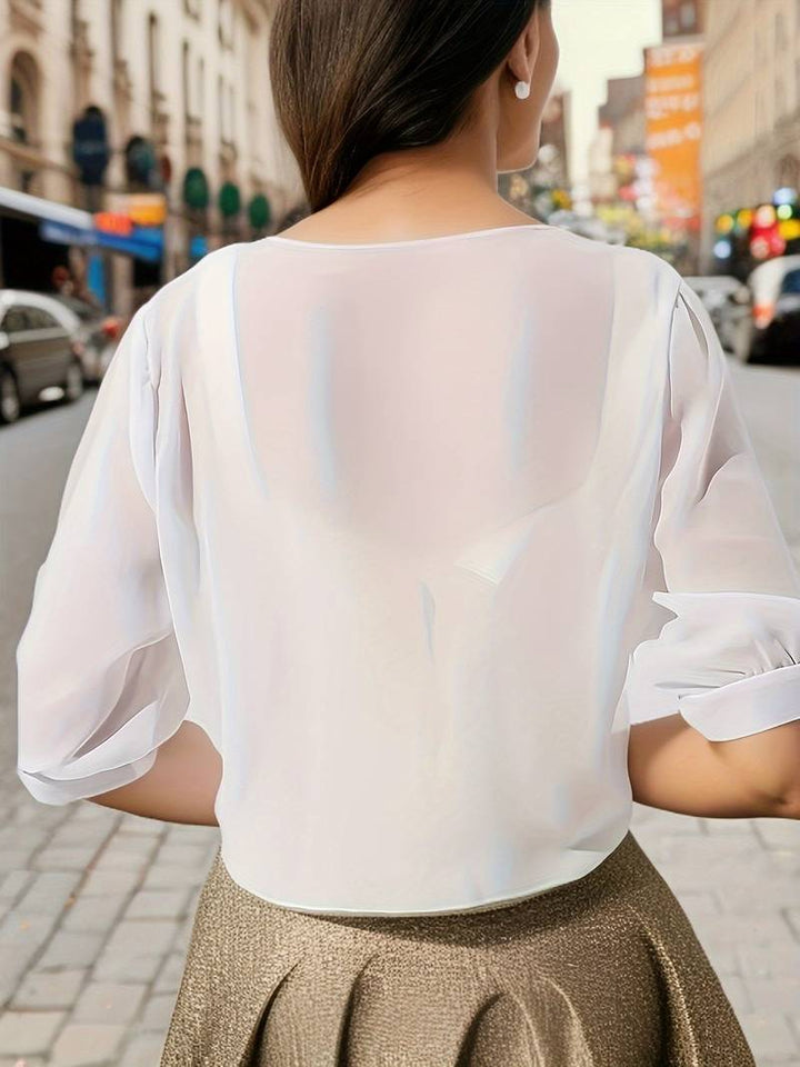 Achterkant van de transparante bolero in Wit